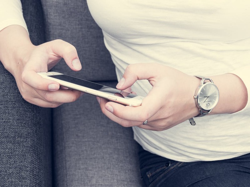 A smartphone user uses their mobile devices via Pexels